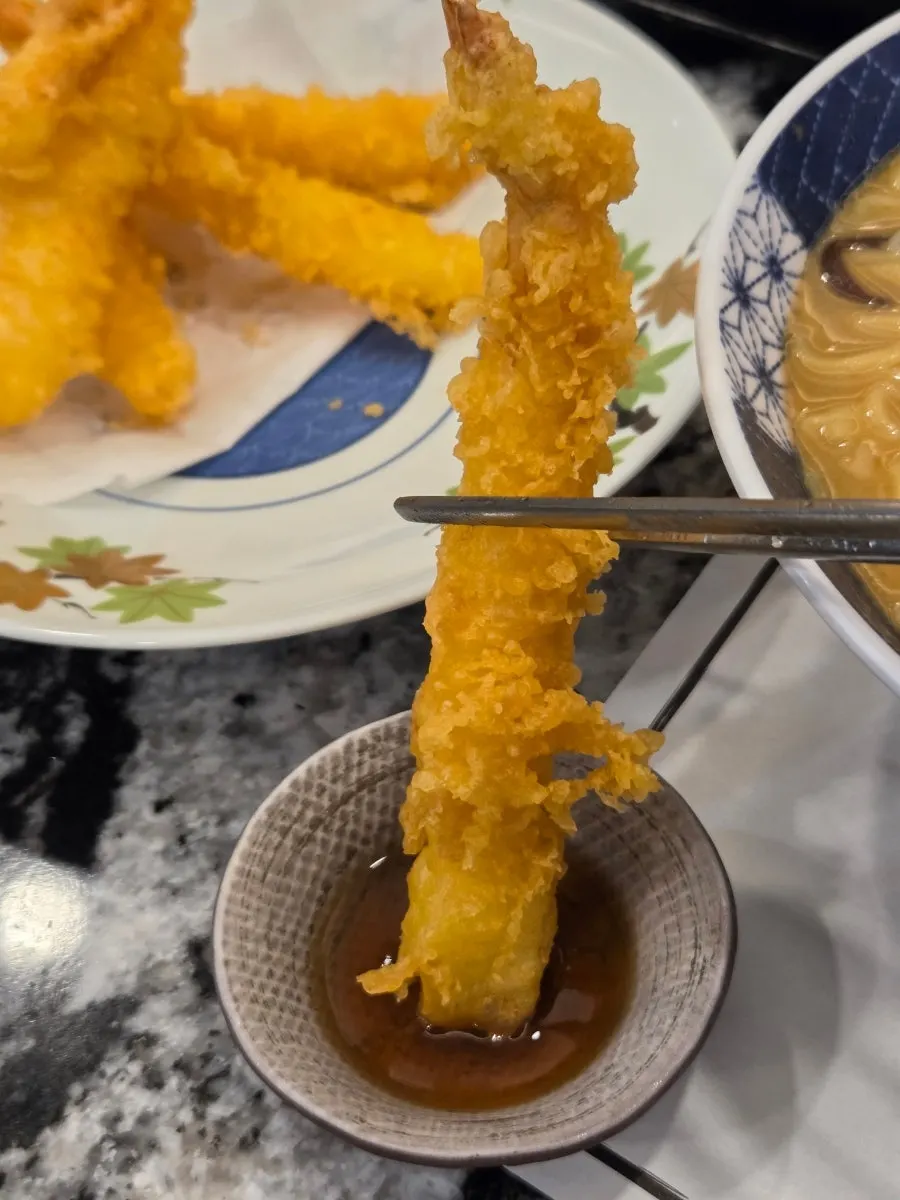 Cross-section of a plump shrimp inside the tempura batter
