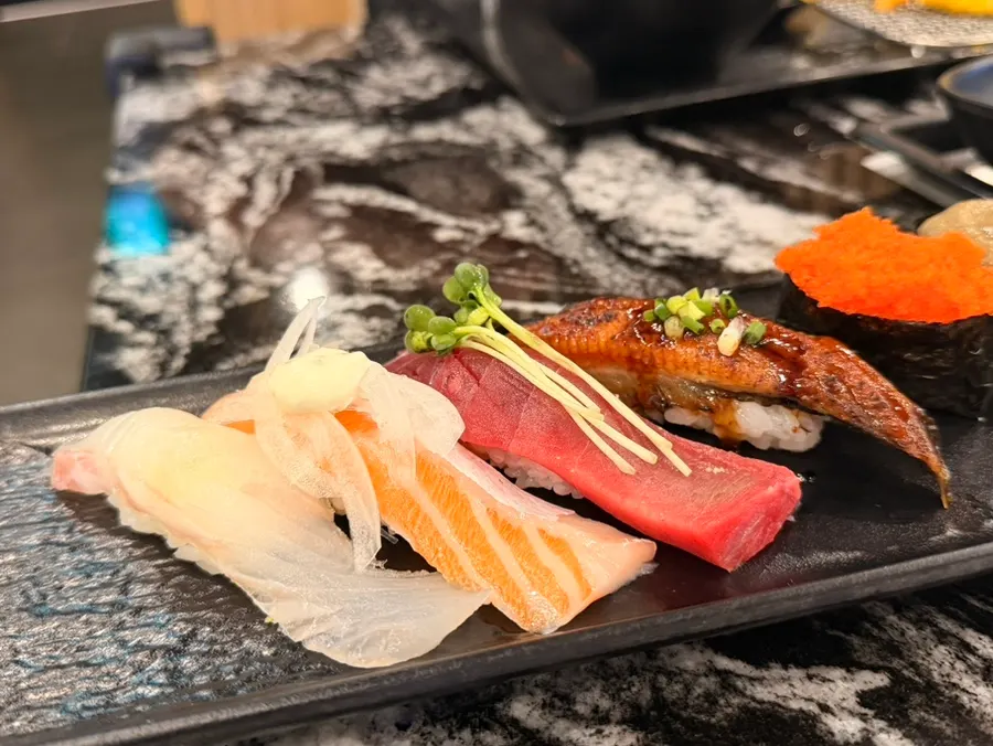 Assortment of flounder, bigeye tuna, salmon belly, and eel sushi
