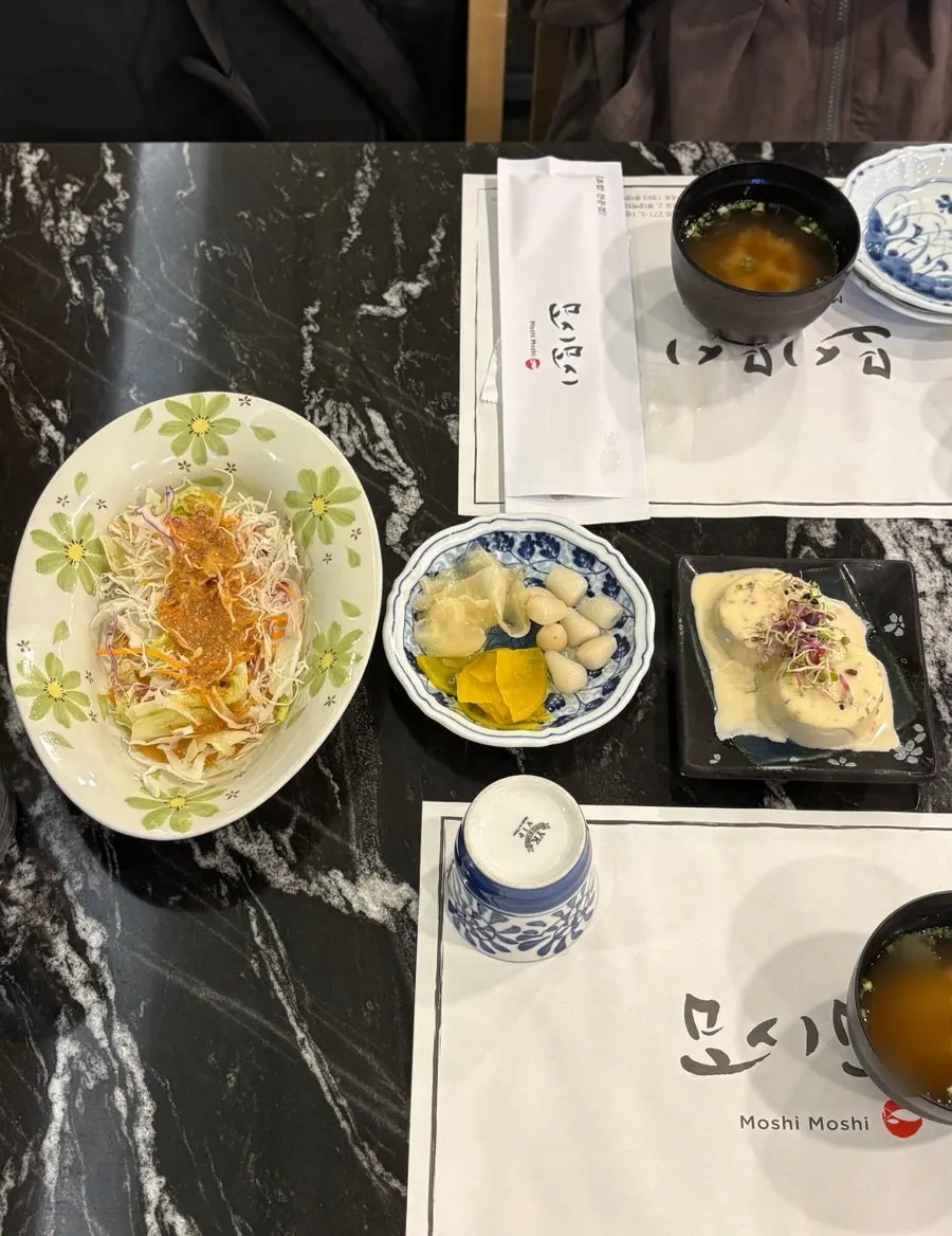 Basic table setting with salad, tofu salad, and miso soup