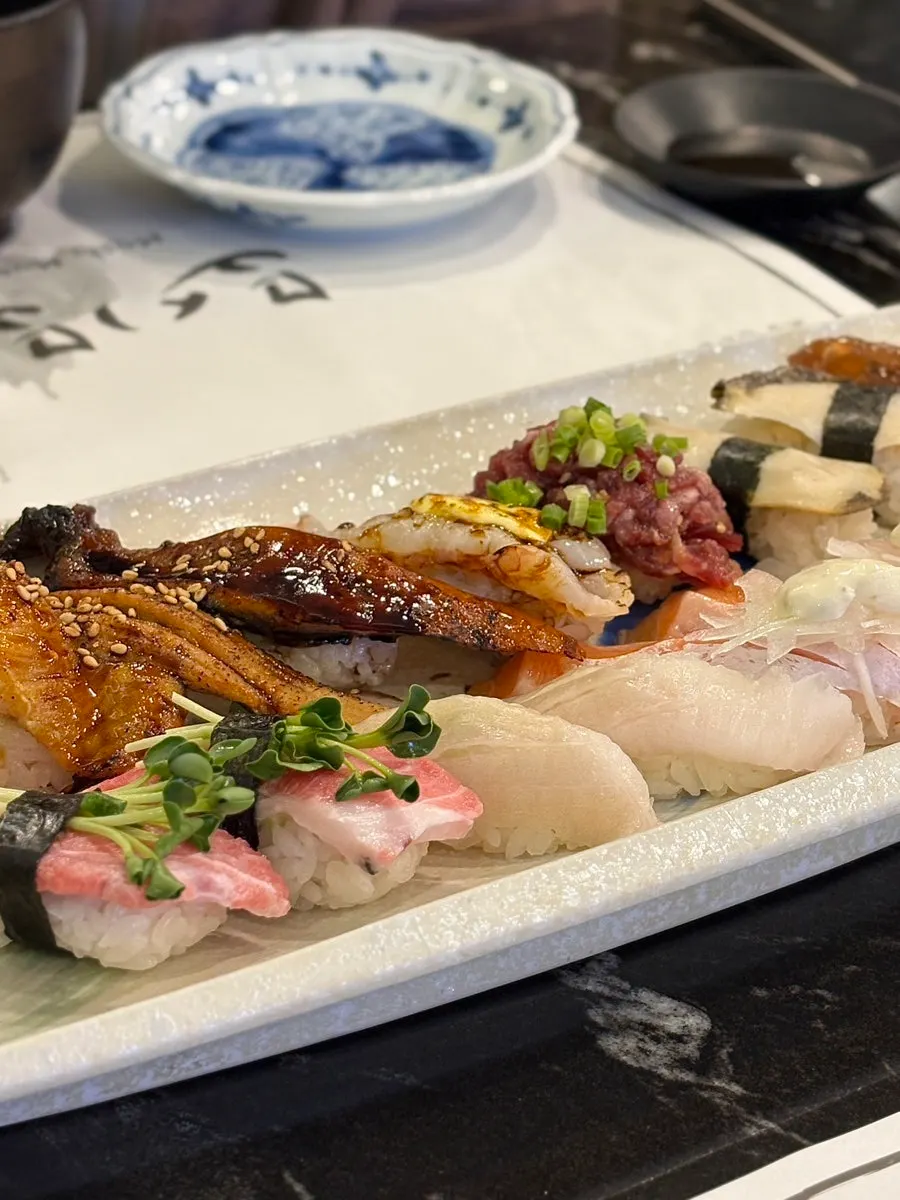 Close-up of eel, beef tartare, and abalone sushi