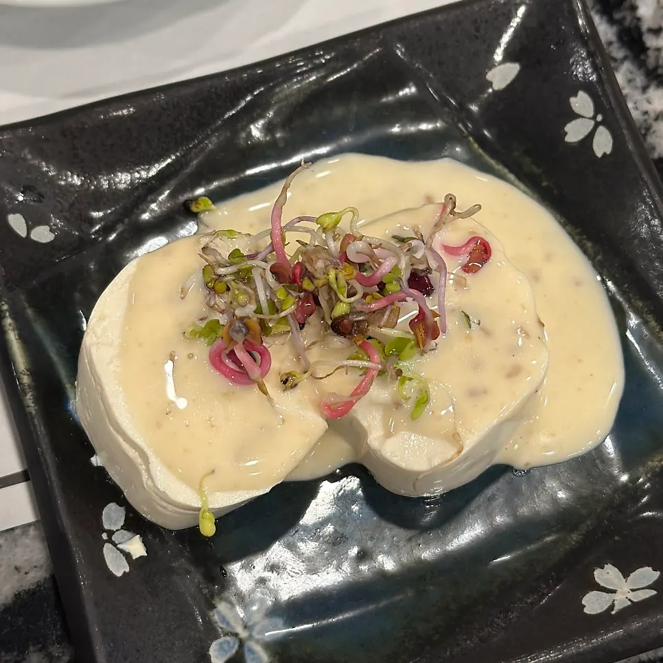Tofu salad topped with a savory sauce