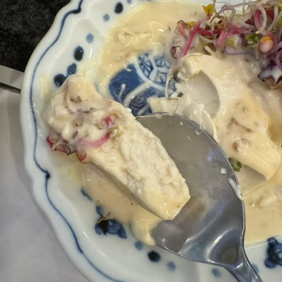 Standard salad, soft tofu, and clear soup served at the start