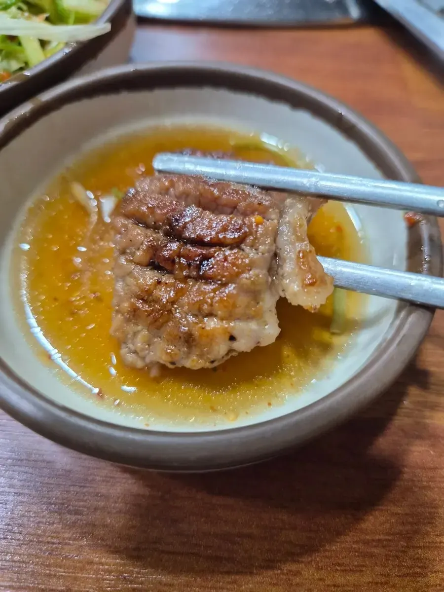 A piece of seasoned rib on a lettuce wrap