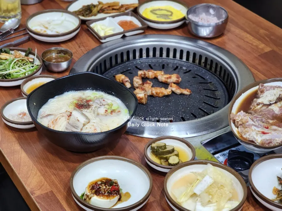 A full spread of Jeju black pork set on the table at Myeongseung Jeju Saenggogi