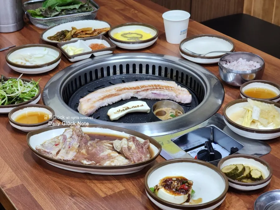 A table filled with meat and assorted side dishes