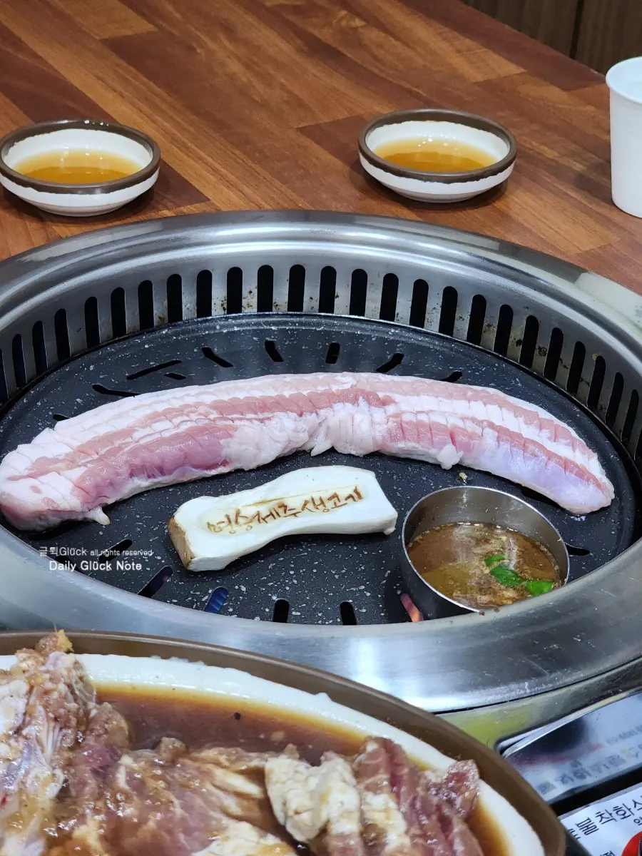 Thick black pork belly and mushrooms on the grill