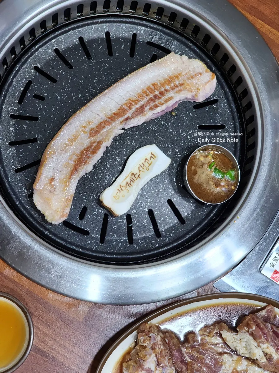 Fresh Jeju pork cooking on the grill