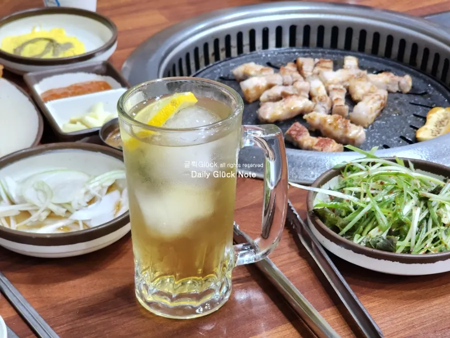 A plate of freshly served meat and the grill