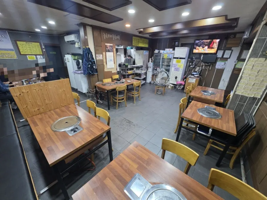 Interior with yellow lighting and wooden table seating