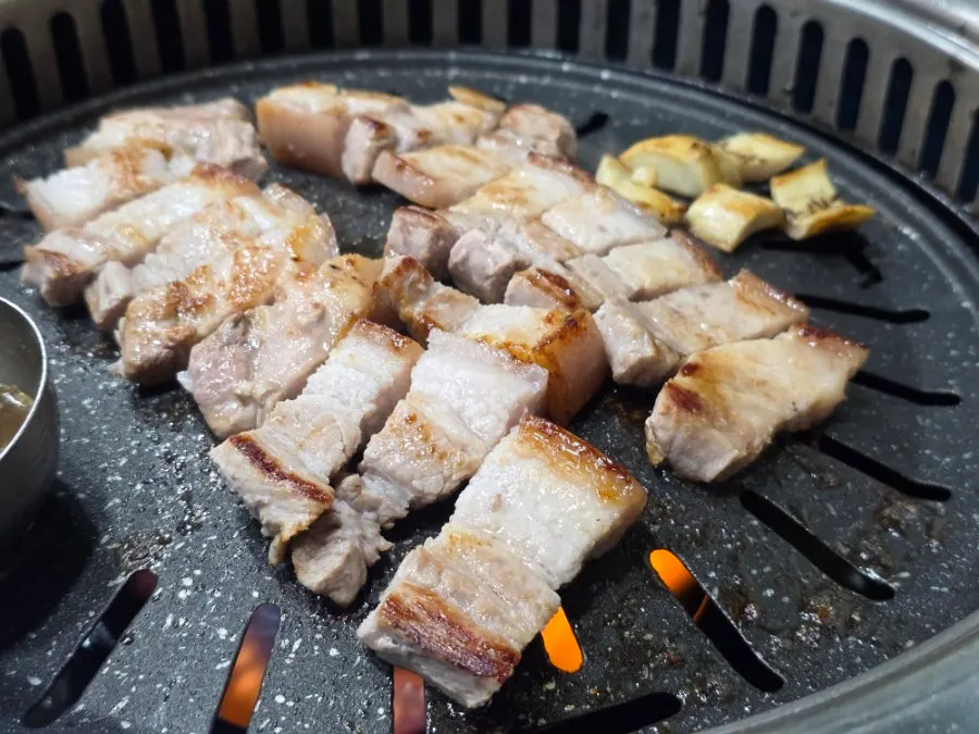 Pork belly grilling to a golden brown