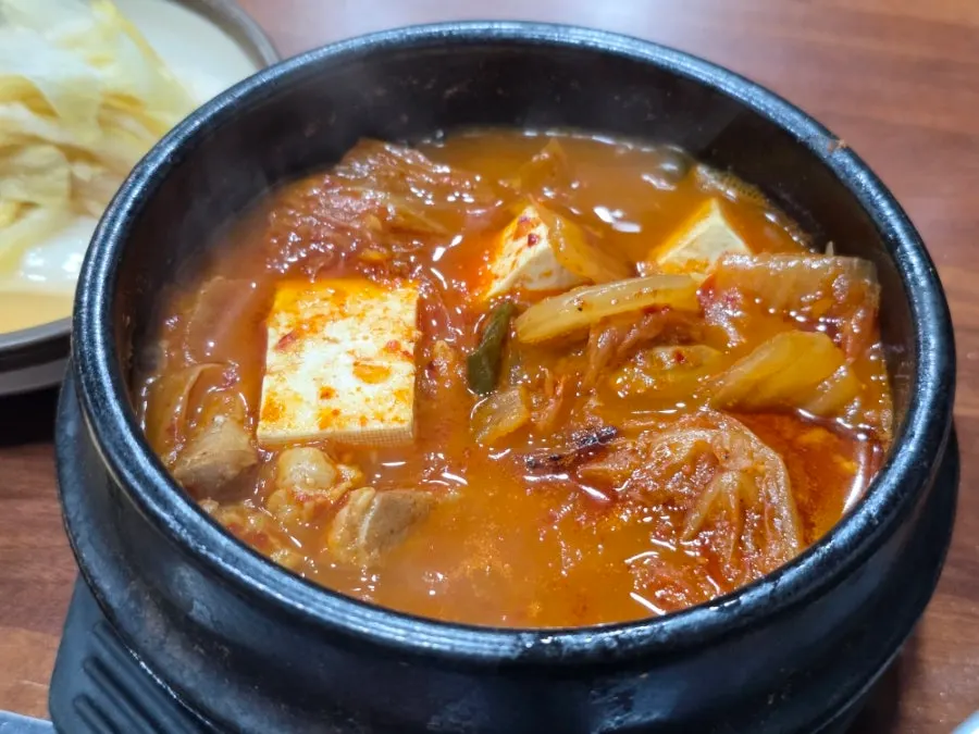 Jeju pork kimchi stew served bubbling in a stone pot