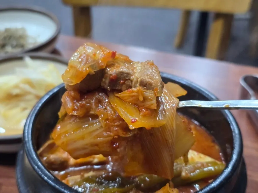 Kimchi stew broth with kimchi, pork, and tofu