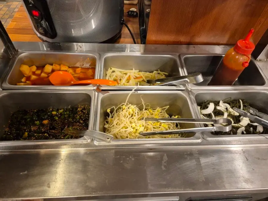 Side dishes neatly arranged at the self-serve bar