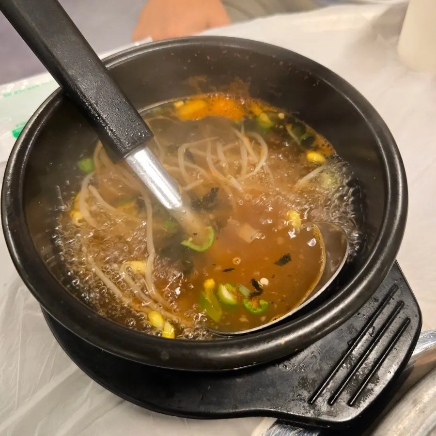 Bottomless spicy bean sprout soup served with the meal