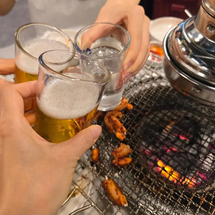 A cold glass of beer alongside kkomjangeo