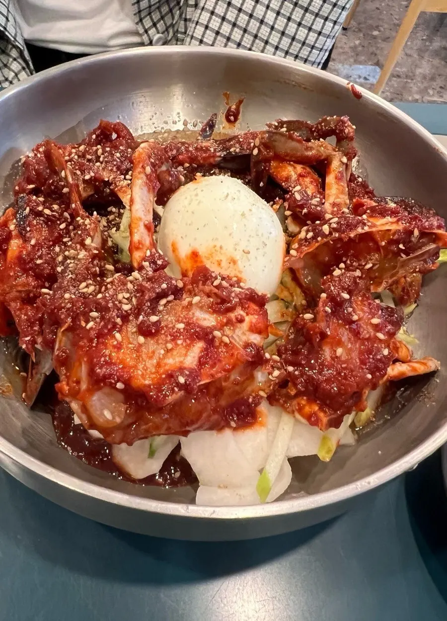 A table set with half-chicken kalguksu and spicy crab bibim naengmyeon