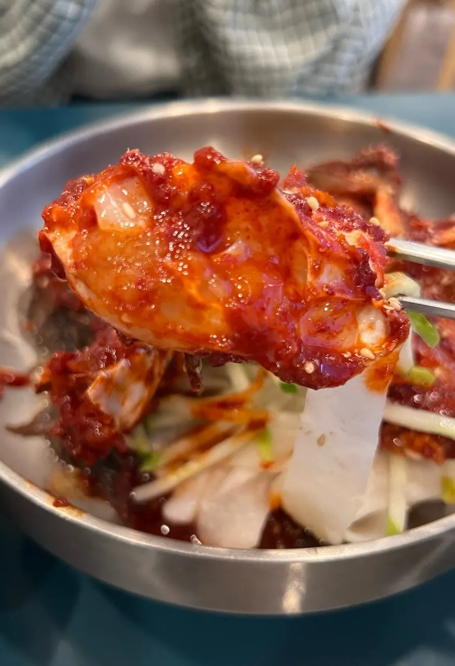 A bowl of bibim naengmyeon topped with spicy seasoned crab
