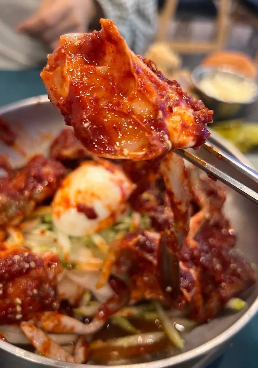Spicy crab bibim naengmyeon topped with a boiled egg