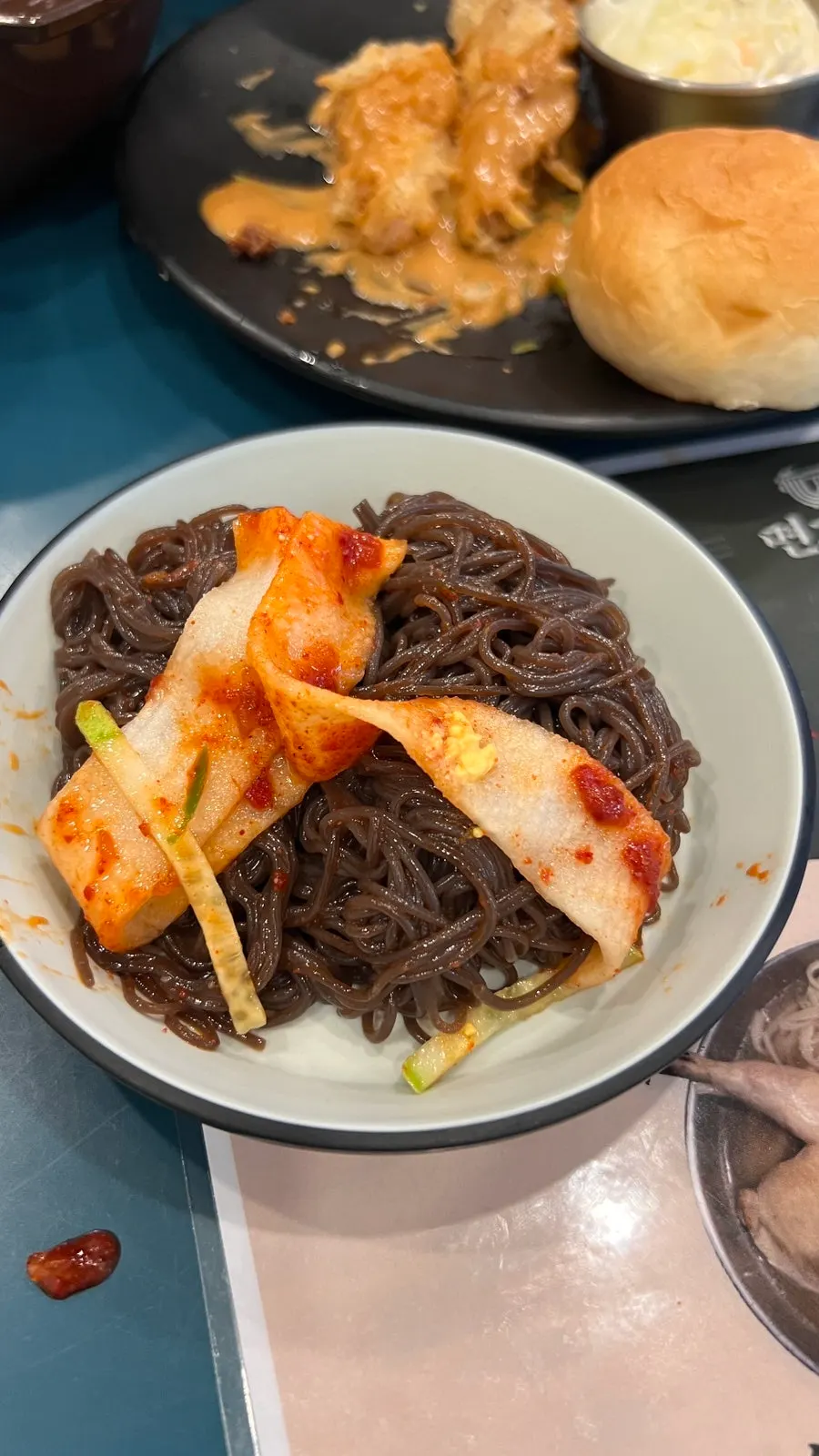 A chopstick-full of mixed spicy crab naengmyeon
