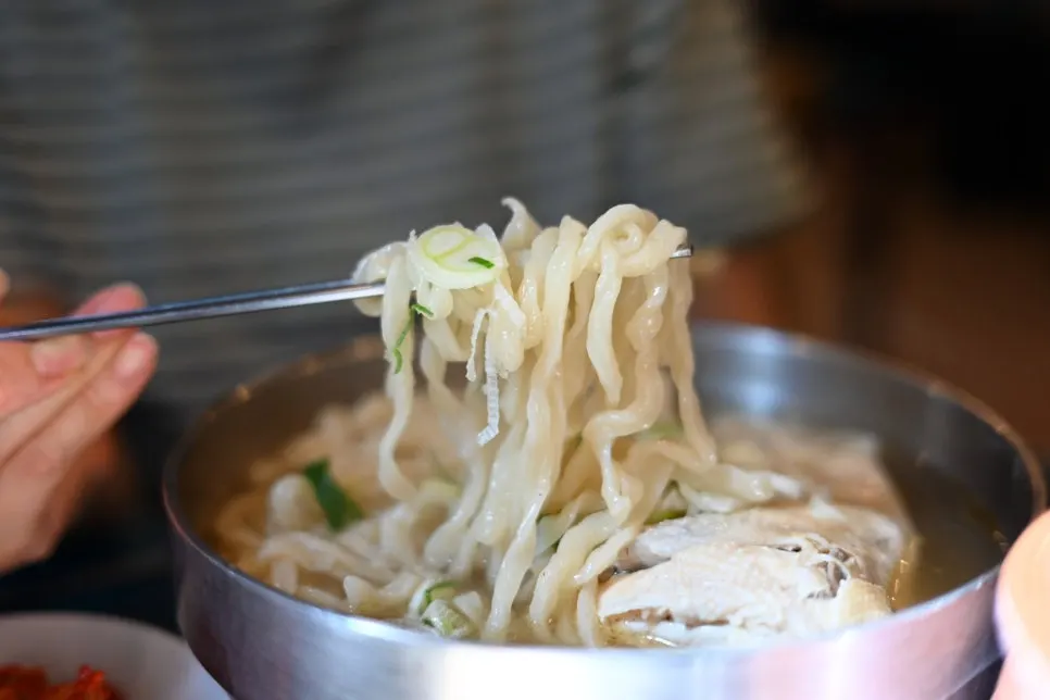 Half-chicken kalguksu with an entire half chicken inside