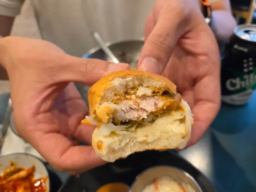 Chicken tenderloin katsu wrapped in a morning bun with vegetables