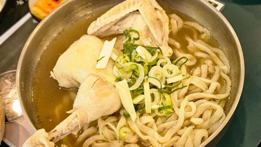 Kalguksu topped with large chunks of chicken