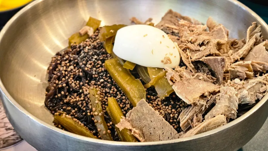Meat-loaded perilla oil naengmyeon piled with meat