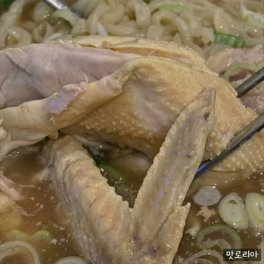 Kalguksu broth with a half chicken inside