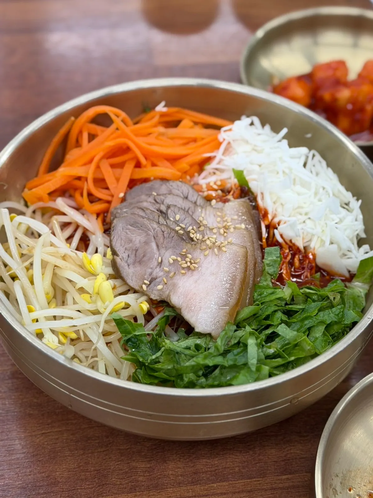 Meat bibim guksu topped with pieces of meat at Myeonjumak