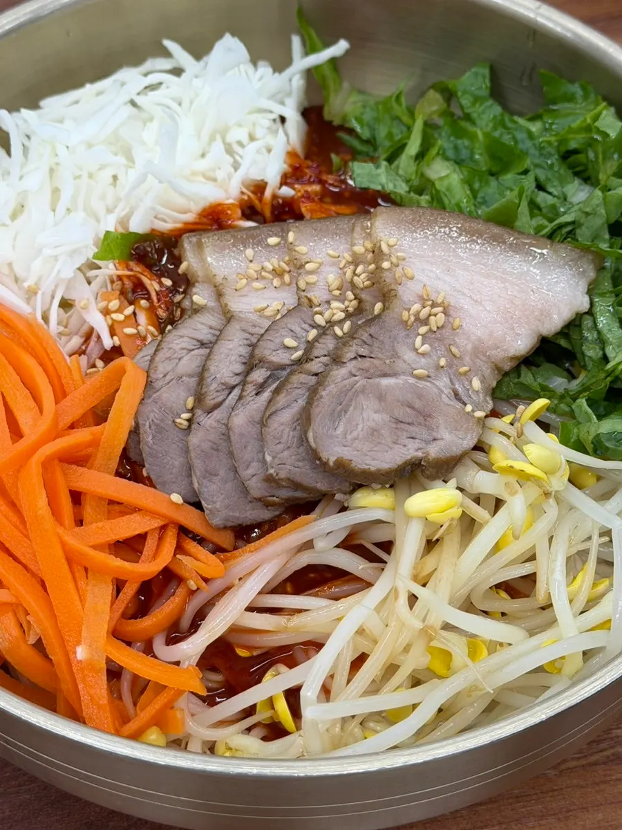 Close-up of the meat bibim guksu loaded with vegetables