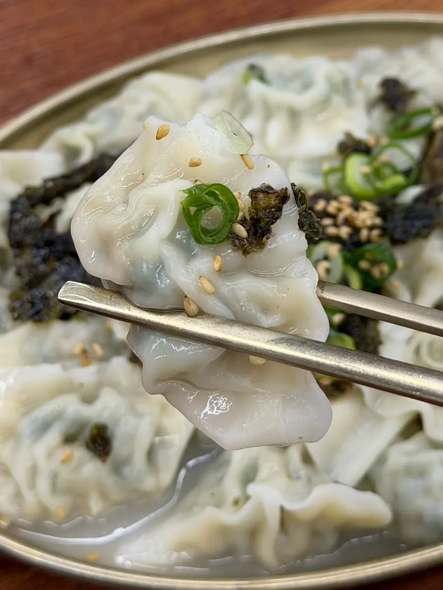 Close-up of mul mandu with meat broth poured over