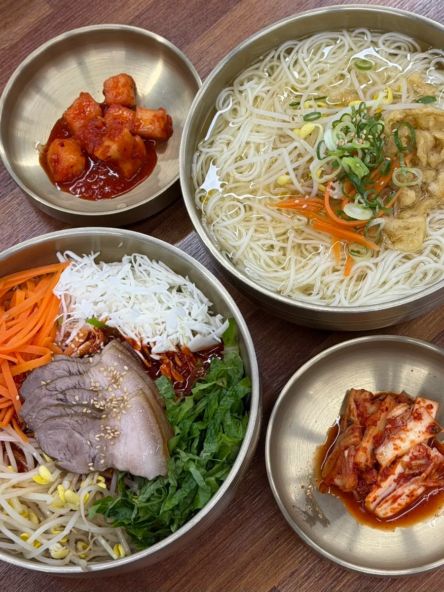 Full table spread of noodles and mul mandu at Myeonjumak