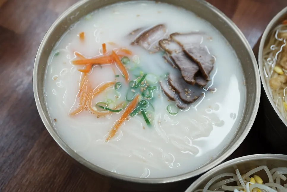 A bowl of Jeju pork noodles with milky-white broth