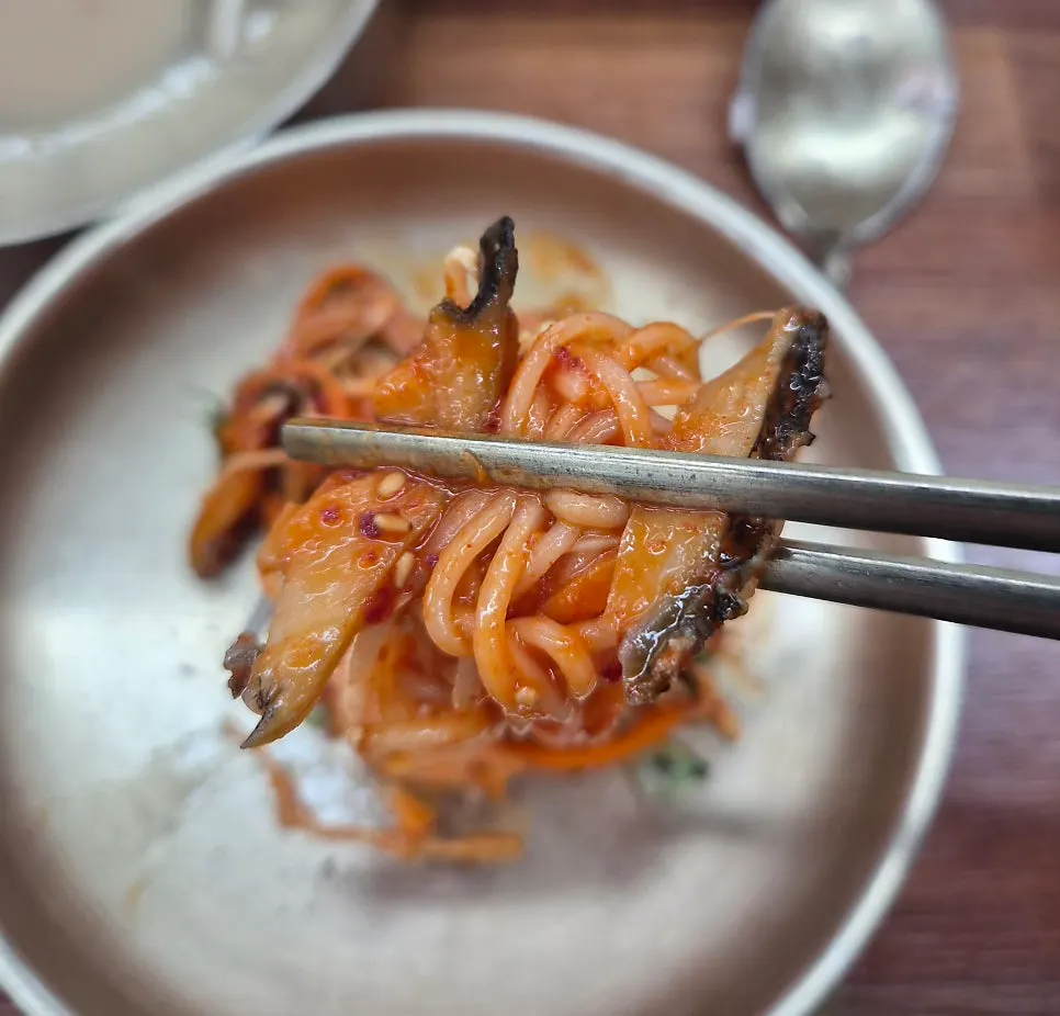 Bibim guksu topped with sliced abalone