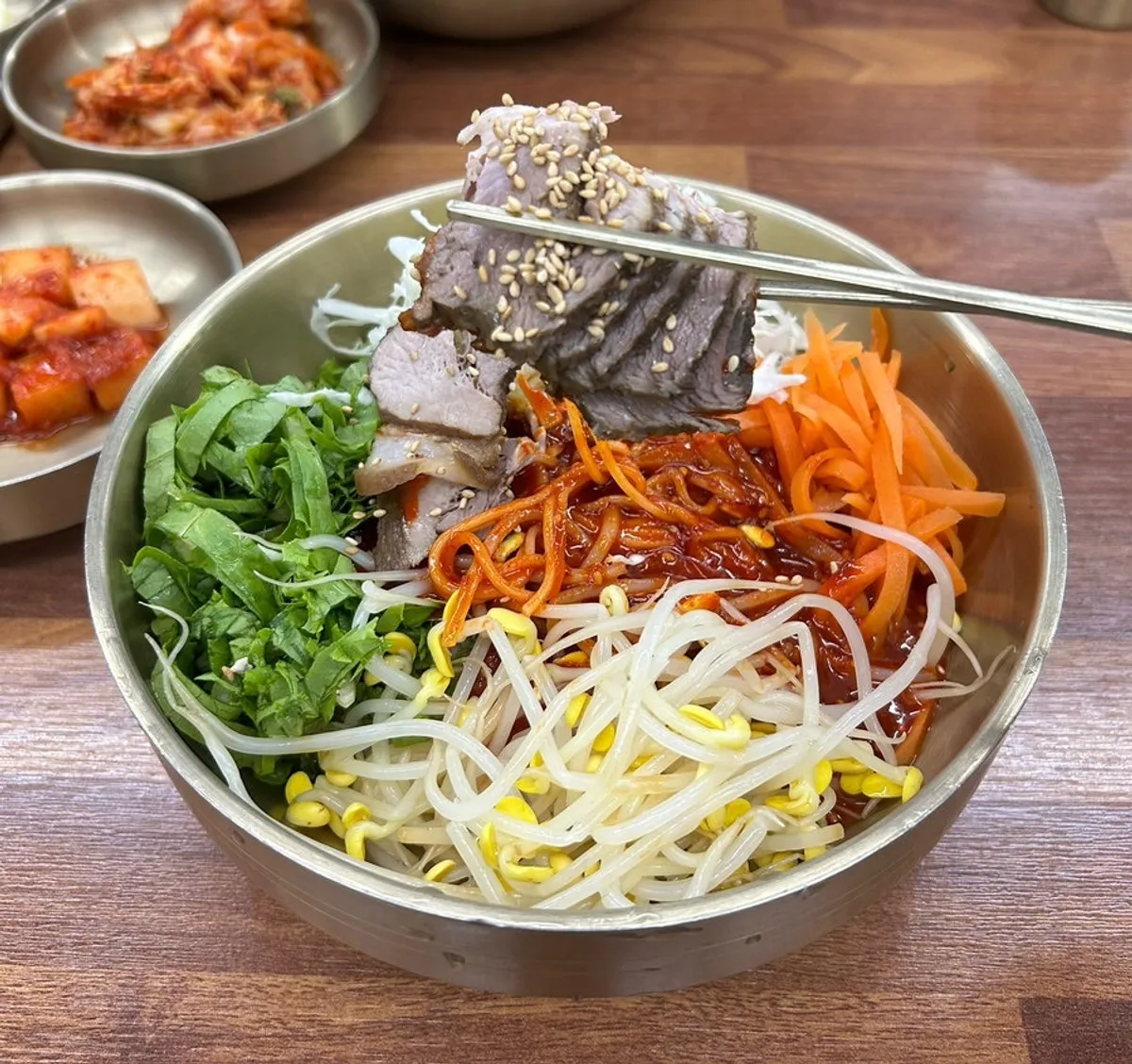 Jeju black pork bibim guksu topped with vegetables