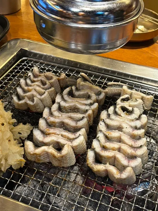 Freshwater eel grilling over charcoal