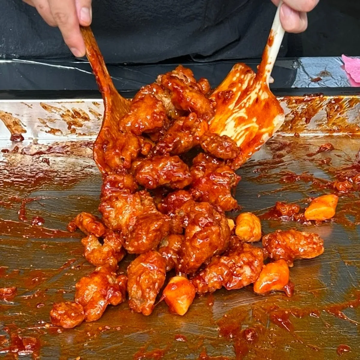 Packaged dakgangjeong and chicken drumsticks from Gimssi Chicken