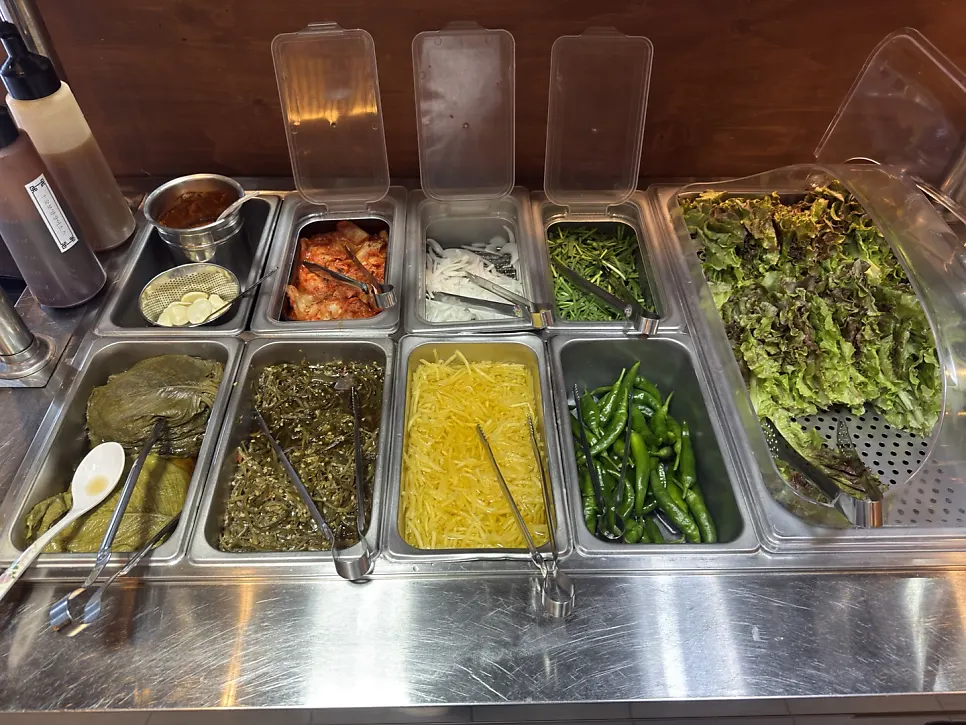 Self-serve bar with lettuce wraps and side dishes