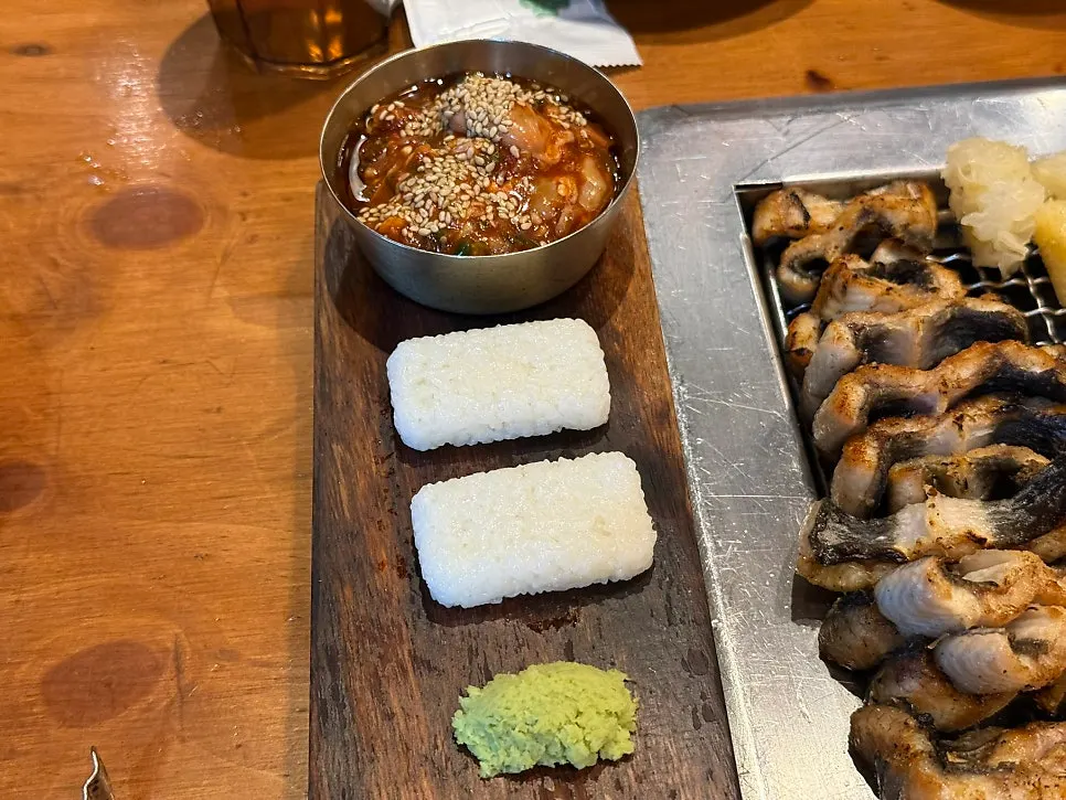 Snow mushroom grilling over charcoal