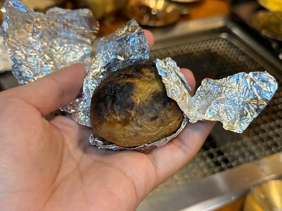 Charcoal-grilled potato eaten last