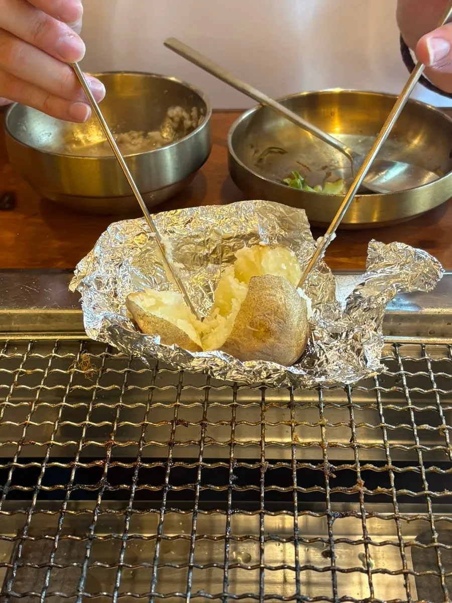 Fluffy potato pulled from the charcoal