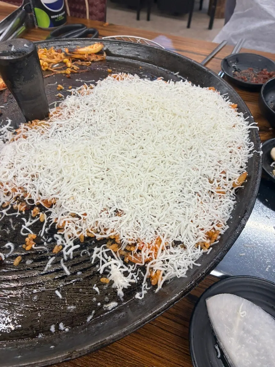 Cheese fried rice pressed onto the cauldron lid