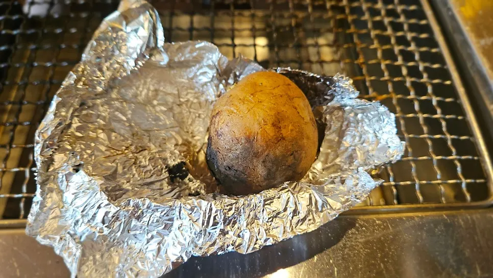 Potatoes grilled over charcoal