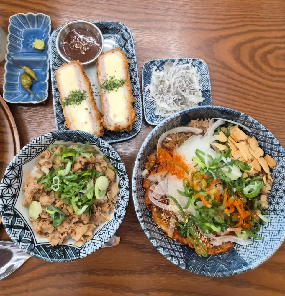 Kimchi pork bowl topped with vegetables and stir-fried kimchi