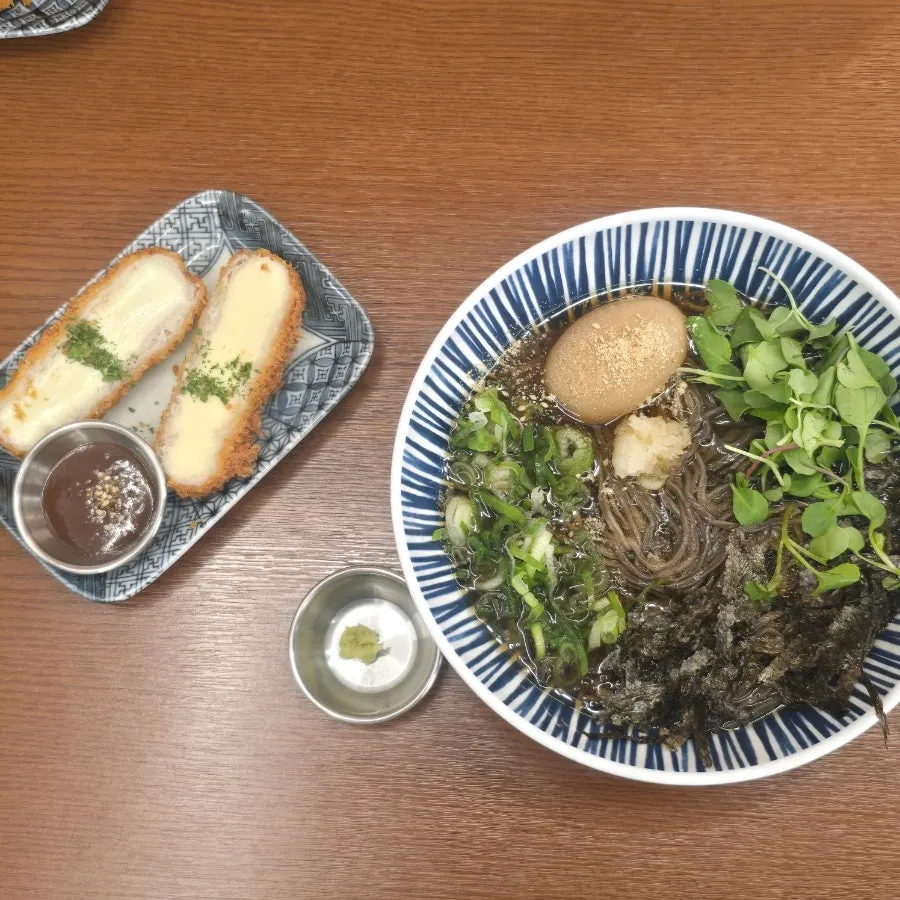 Self-serve bar with udon broth, kimchi and pickled radish