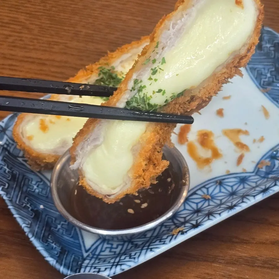 Cross-section of mozzarella cheese katsu showing crispy breading