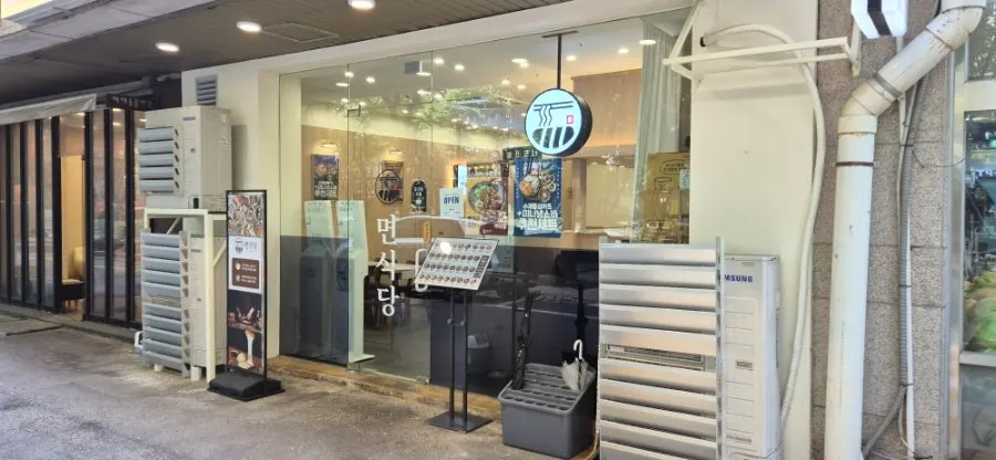Interior of Myeon Sikdang Godeok Station Branch, which serves ramen, rice bowls, and tonkatsu