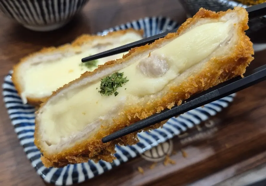 Cross-section of cheese katsu cut in half