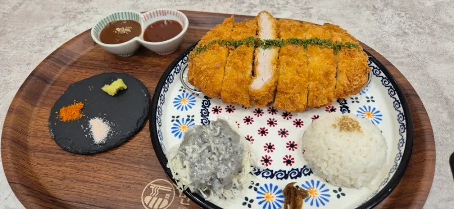 Loin tonkatsu served with cabbage salad and pickled burdock root