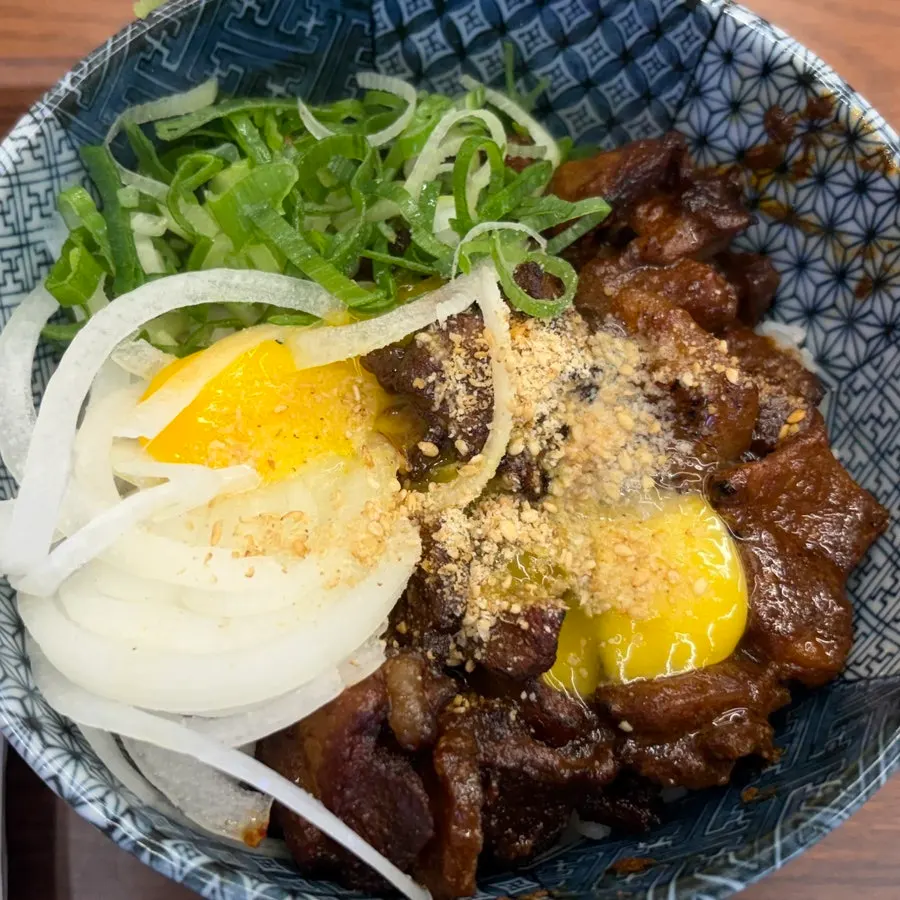 Egg yolk on top of the spicy rib rice bowl